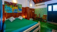 room with wall painting and green bed sheet