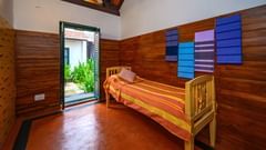 room with single bed and entrance door 