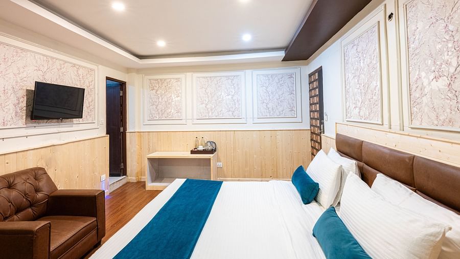 an image of a bedroom with a tea and a coffee maker placed on a table at Avianna New Mandala Hotel & Spa, Darjeeling