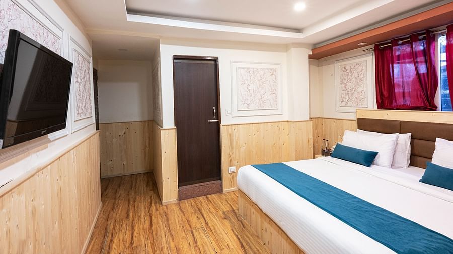 an image of a premium room with balcony with wooden finished flooring at Avianna New Mandala Hotel & Spa, Darjeeling