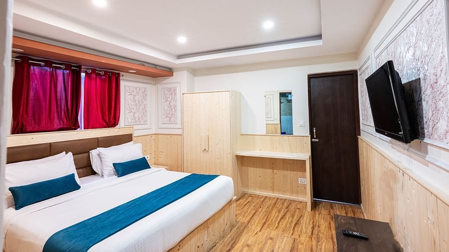 an image of a premium room with balcony with a wall mounted television at Avianna New Mandala Hotel & Spa, Darjeeling
