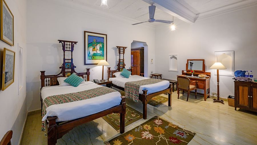  Deo Bagh - 17th Century, Gwalior - twin sharing beds with turquoise pillows on top of it at the Ranjit Raje Mahal - Naubagh / Garden View hotel stay inn Gwalior