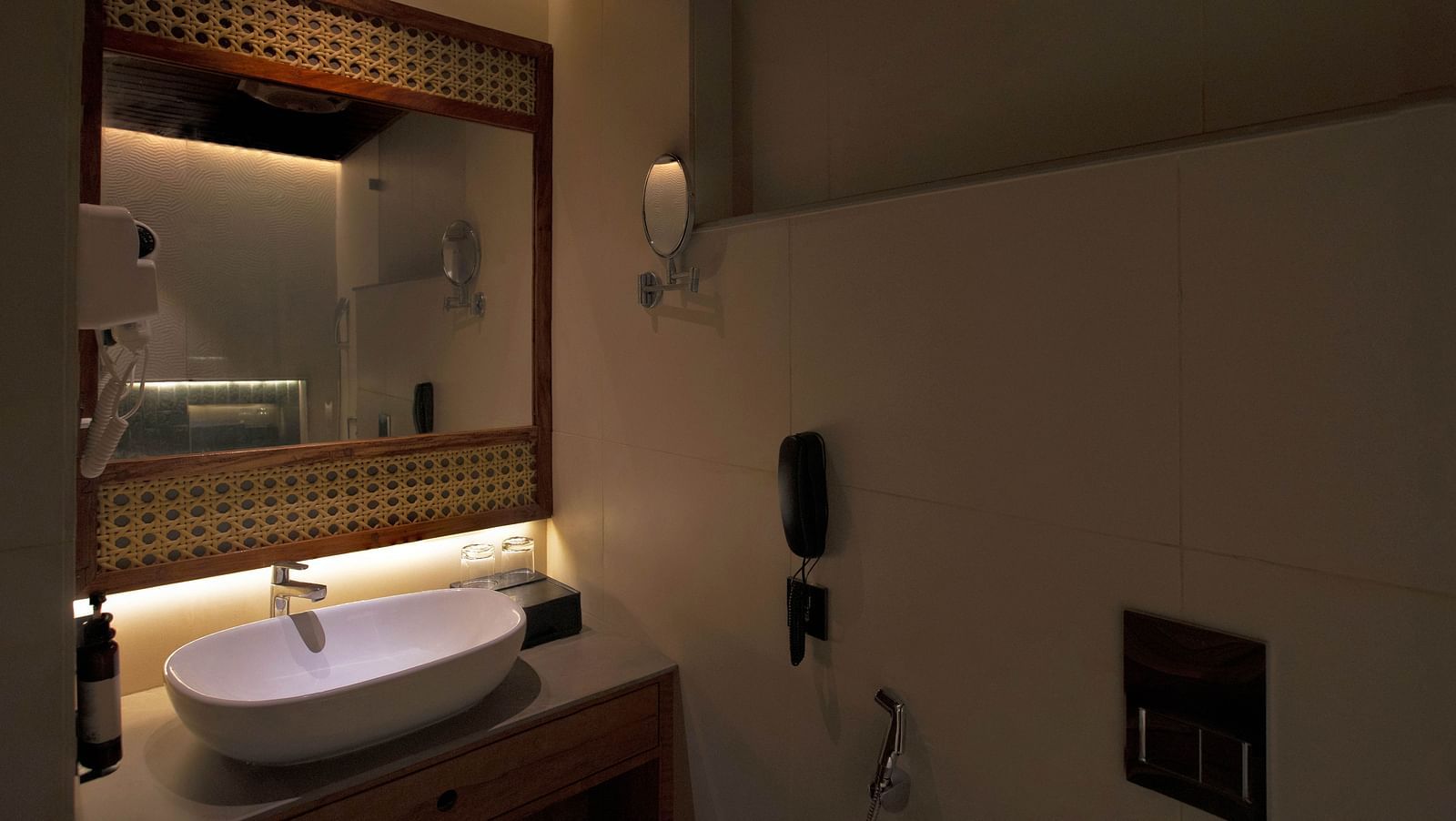 Image of bathroom of Coral Sapphire at Coral Reef Resort and Spa in Havelock featuring a sink with a mirror over it and a tiny mirror mounted on the wall next to it