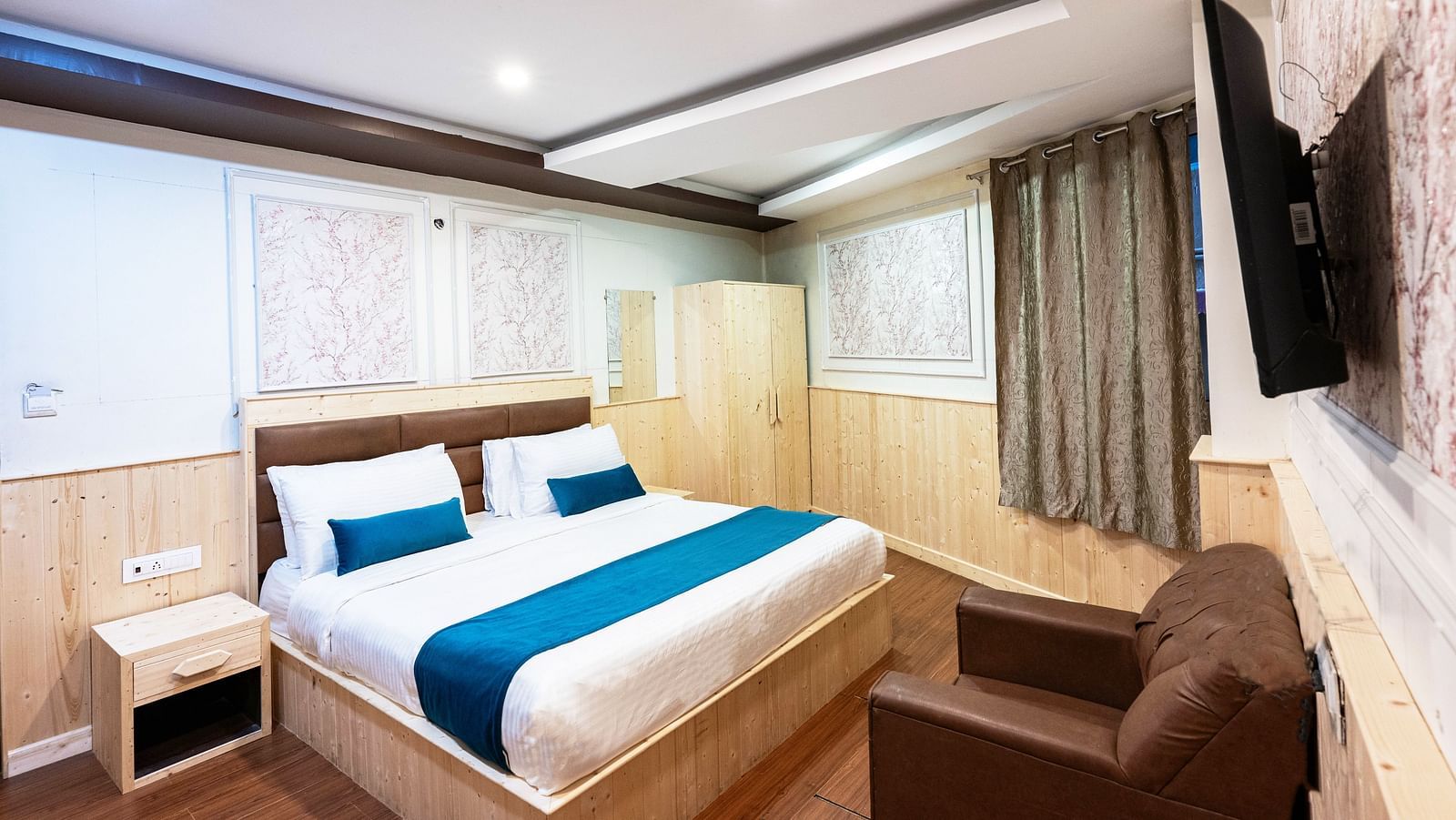 an image of a deluxe room with a wall mounted television at Avianna New Mandala Hotel & Spa, Darjeeling