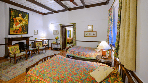 Kashmir room with a fireplace and double bed for a comfortable stay - Ramgarh Bungalows, Nainital.