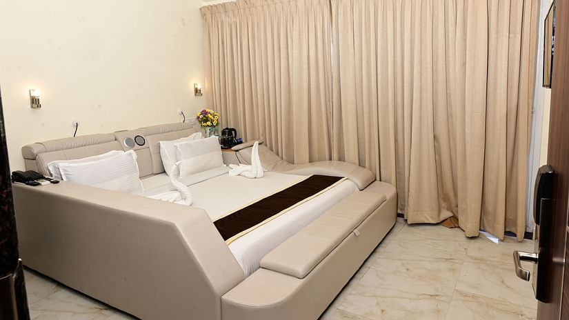 a modern double bed with pillows on top inside one of the rooms - VITS shanti solitaire, North Goa