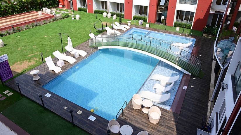 an aerial view of the swimming pool, loungers and the bridge at VITS shanti solitaire, North Goa