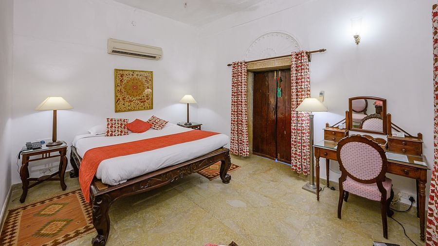 Deo Bagh - 17th Century, Gwalior - view of the king size bed and a work station at the Dhanur Mahal - Naubagh / Garden View