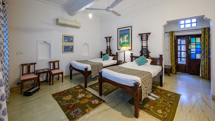 Deo Bagh - 17th Century, Gwalior - twin sharing beds with turquoise pillows on top of it at the Ranjit Raje Mahal - Naubagh / Garden View hotel stay inn Gwalior