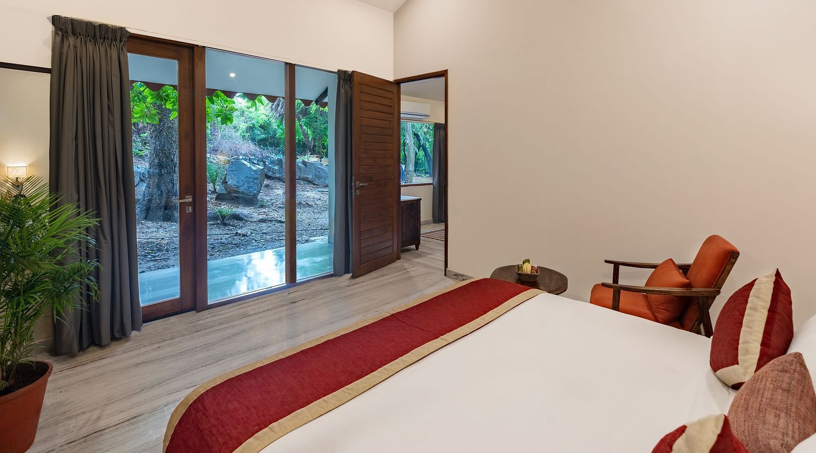 image of a bedroom at the luxury suite villa featuring a king size bed and a balcony with huge french windows at our resort in udaipur