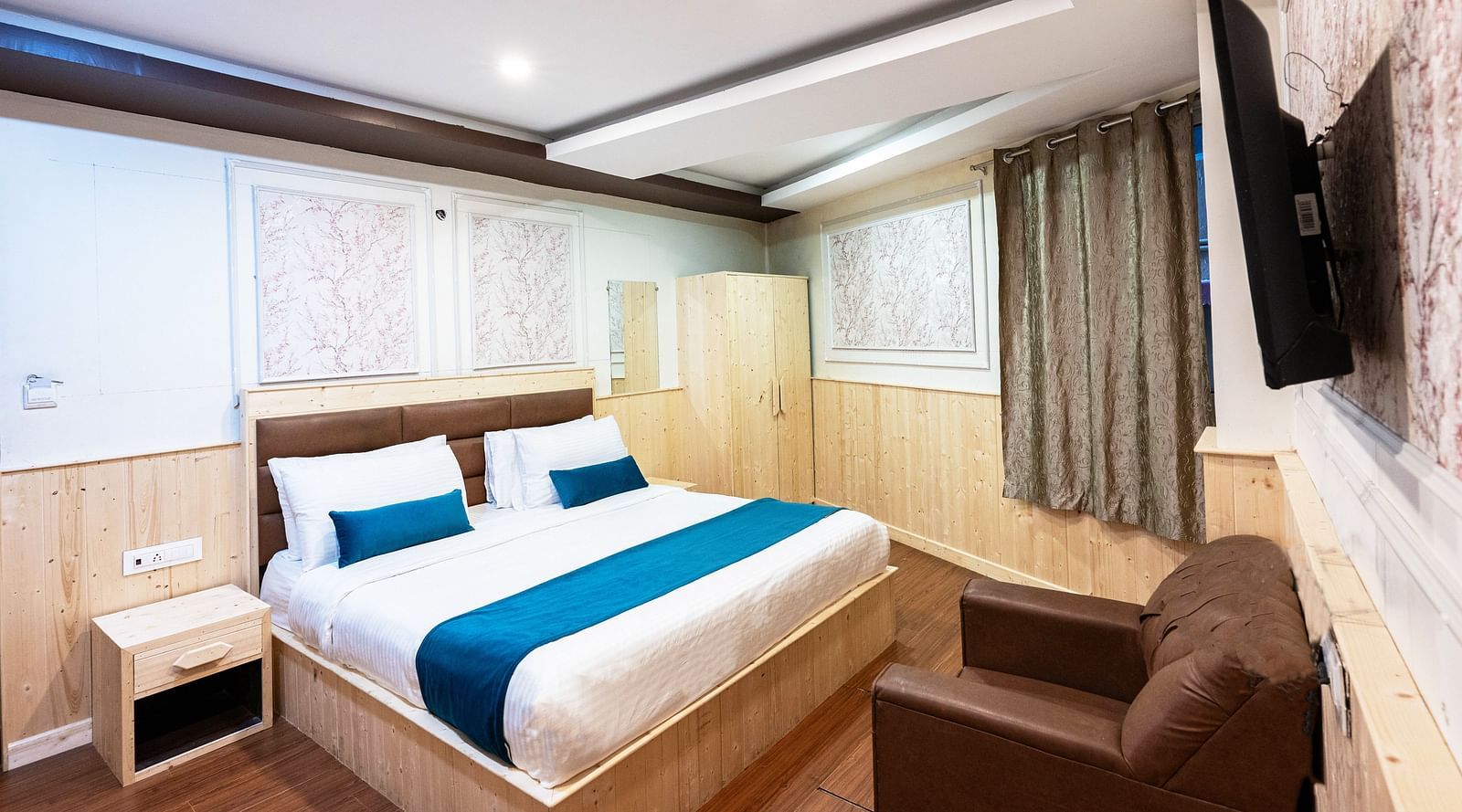 an image of a deluxe room with a wall mounted television at Avianna New Mandala Hotel & Spa, Darjeeling