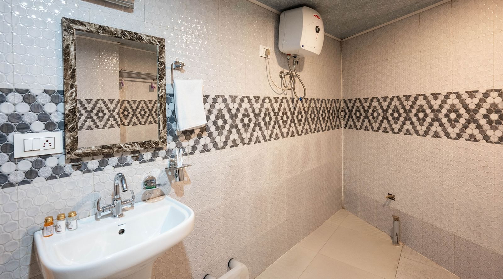 an image of a washroom with a wash basin and a mirror at Avianna New Mandala Hotel & Spa, Darjeeling