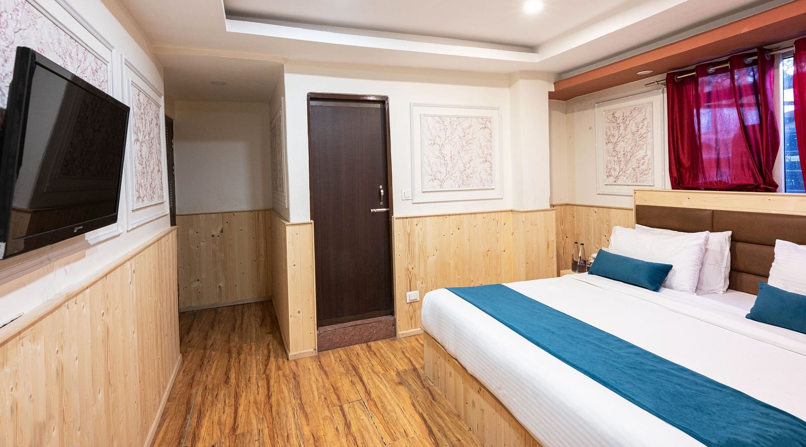an image of a premium room with balcony with wooden finished flooring at Avianna New Mandala Hotel & Spa, Darjeeling