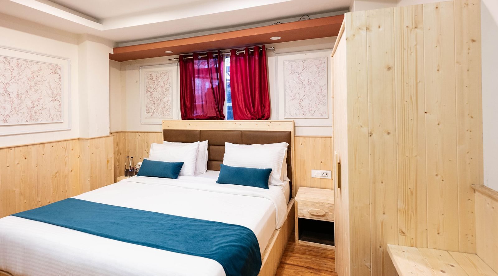 an image of a premium room with balcony featuring a scenic window behind the bed at Avianna New Mandala Hotel & Spa, Darjeeling