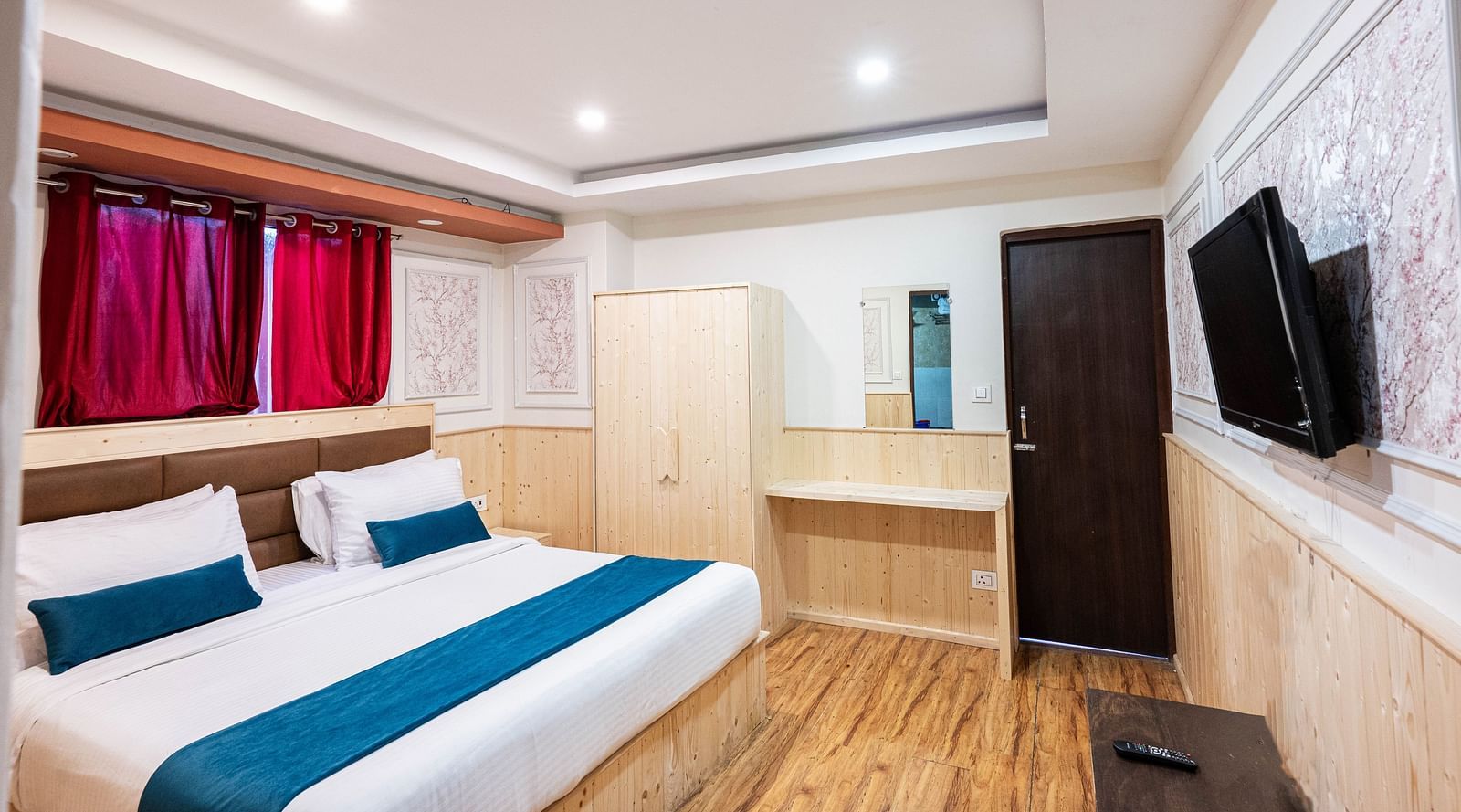 an image of a premium room with balcony with a wall mounted television at Avianna New Mandala Hotel & Spa, Darjeeling
