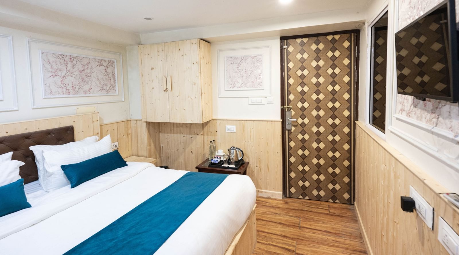 an image of a standard room with a wall mounted television at Avianna New Mandala Hotel & Spa, Darjeeling