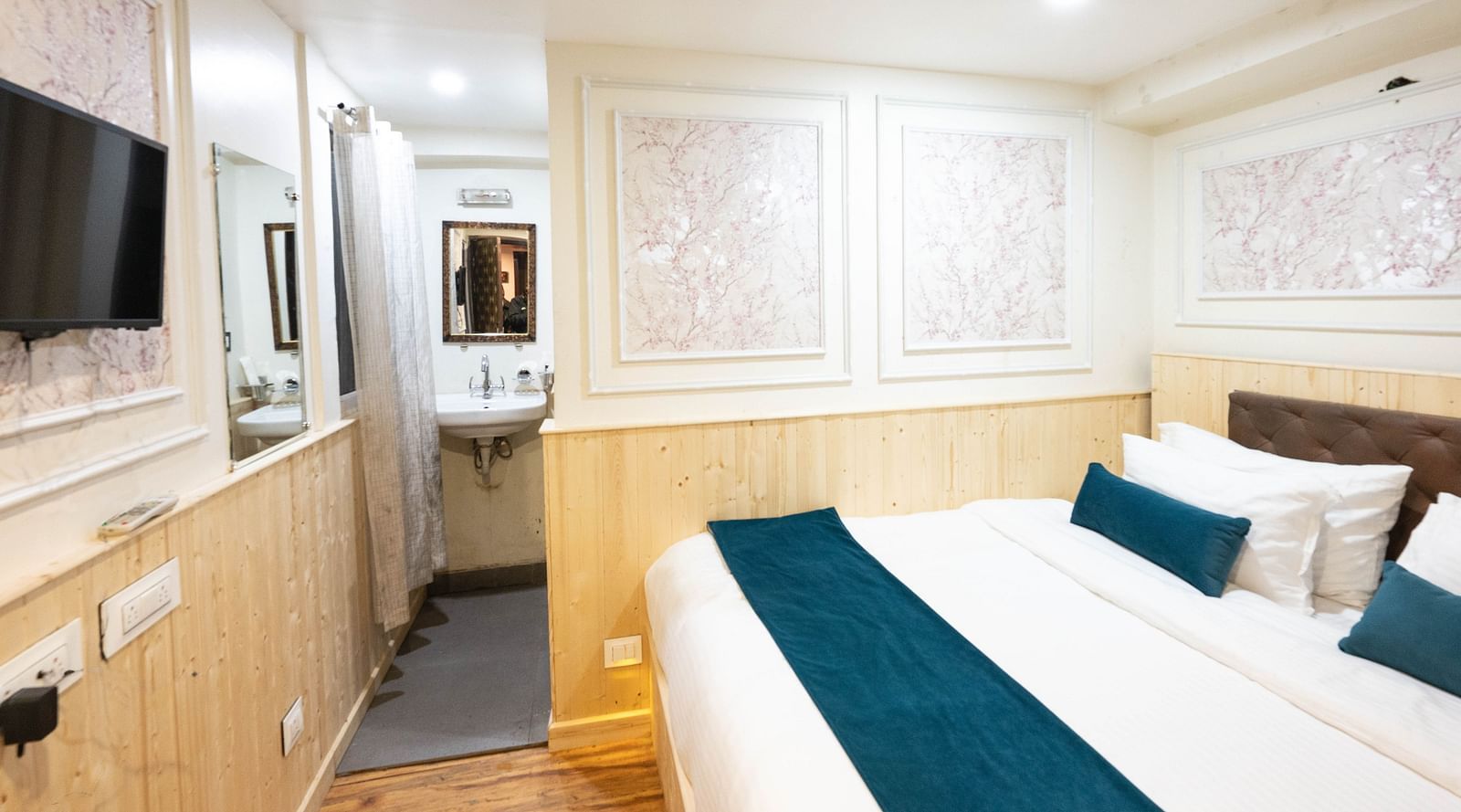 an image of a standard room with a  king size bed and illuminating white lights at Avianna New Mandala Hotel & Spa, Darjeeling