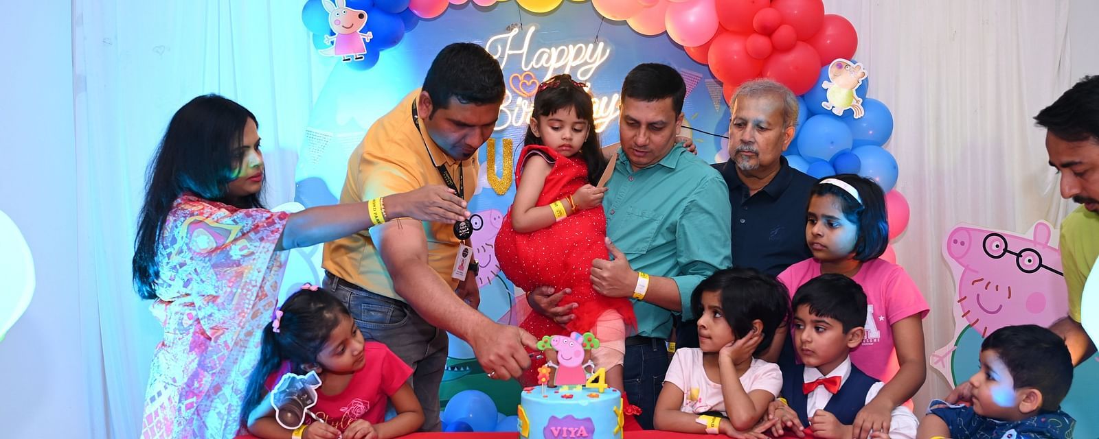 Family celebrating a child's birthday party with a colorful cake and decorations |  Diamond Parks, Pune