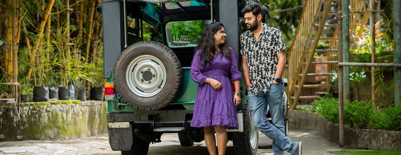 A couple standing in front of a jeep for photoshoot at Parakkat Nature Hotel & Resorts, Munnar 19