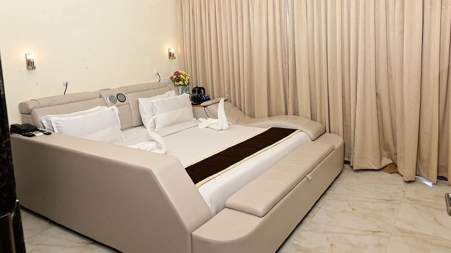a modern double bed with pillows on top inside one of the rooms - VITS shanti solitaire, North Goa
