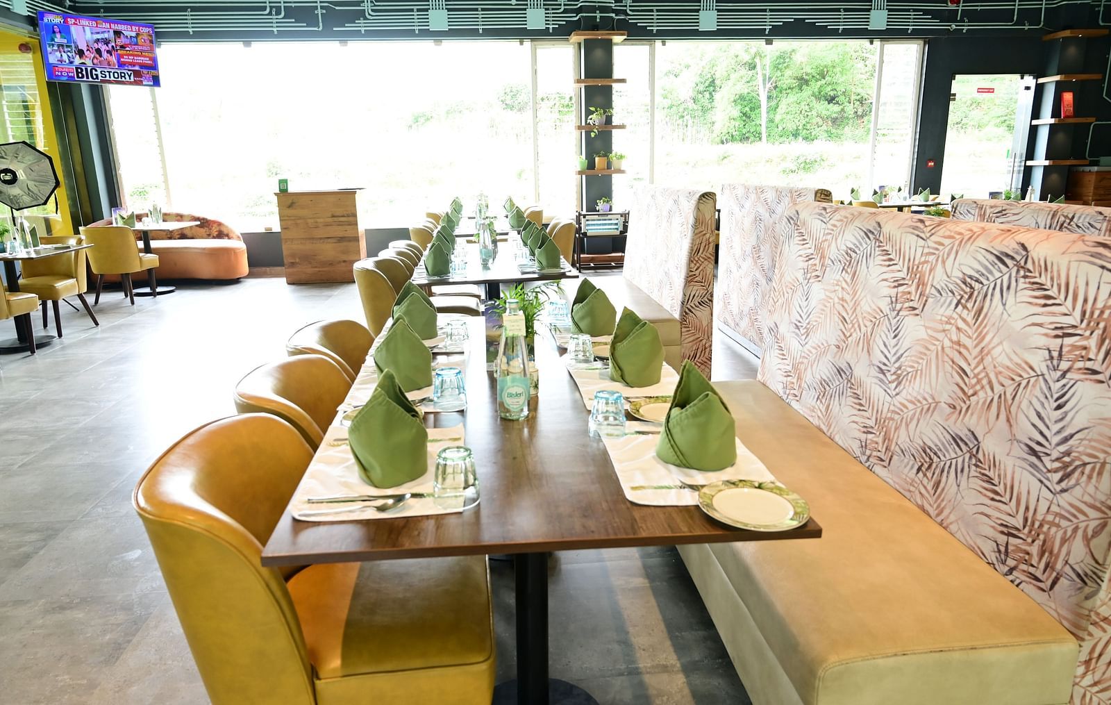 An image of a restaurant with seating arrangement, cutlery, and decorative items - GReaT trails Kodaikanal by GRT Hotels