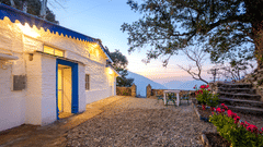 An overview of the entrance to Blue Cottage in the evening with the sun setting in the background - The Ramgarh Bungalows - 19th Century.
