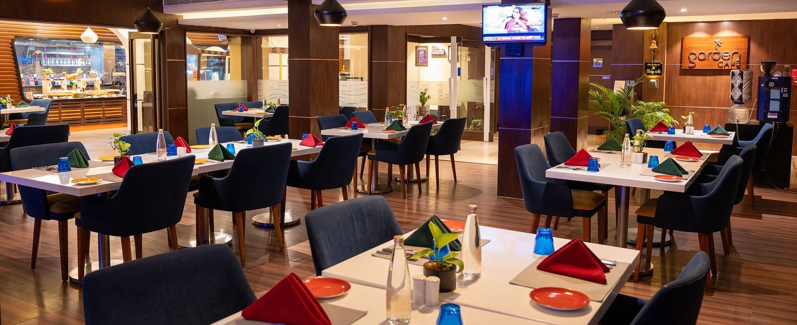An image of  a dining space with a television  at Grand Kakinada by GRT Hotels