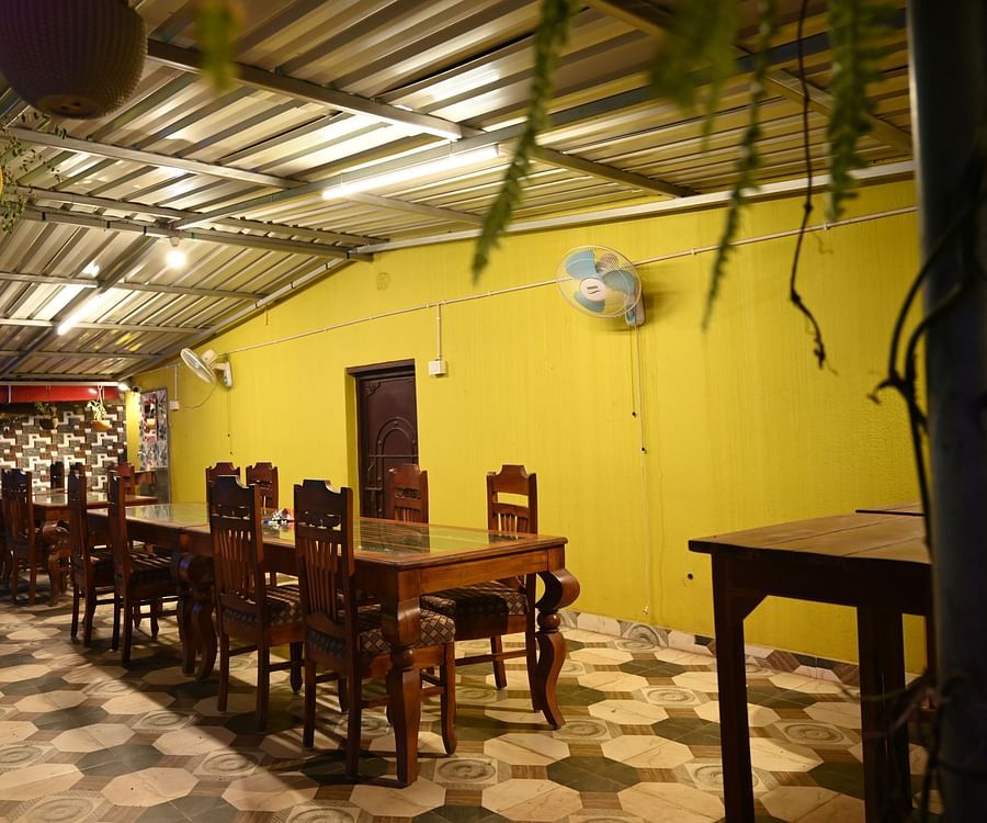 Dining table at Zestful Bites Restaurant in McCluskieganj