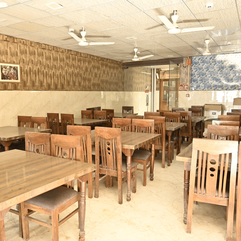 Seating arrangements with table and chairs arranged at Agra Prasadham - Hotel Goverdhan, Agra