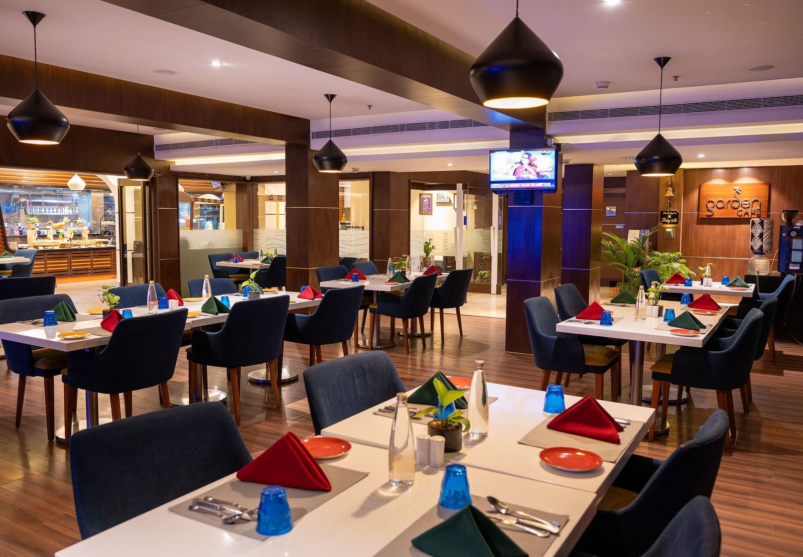An image of  a dining space with a television  at Grand Kakinada by GRT Hotels