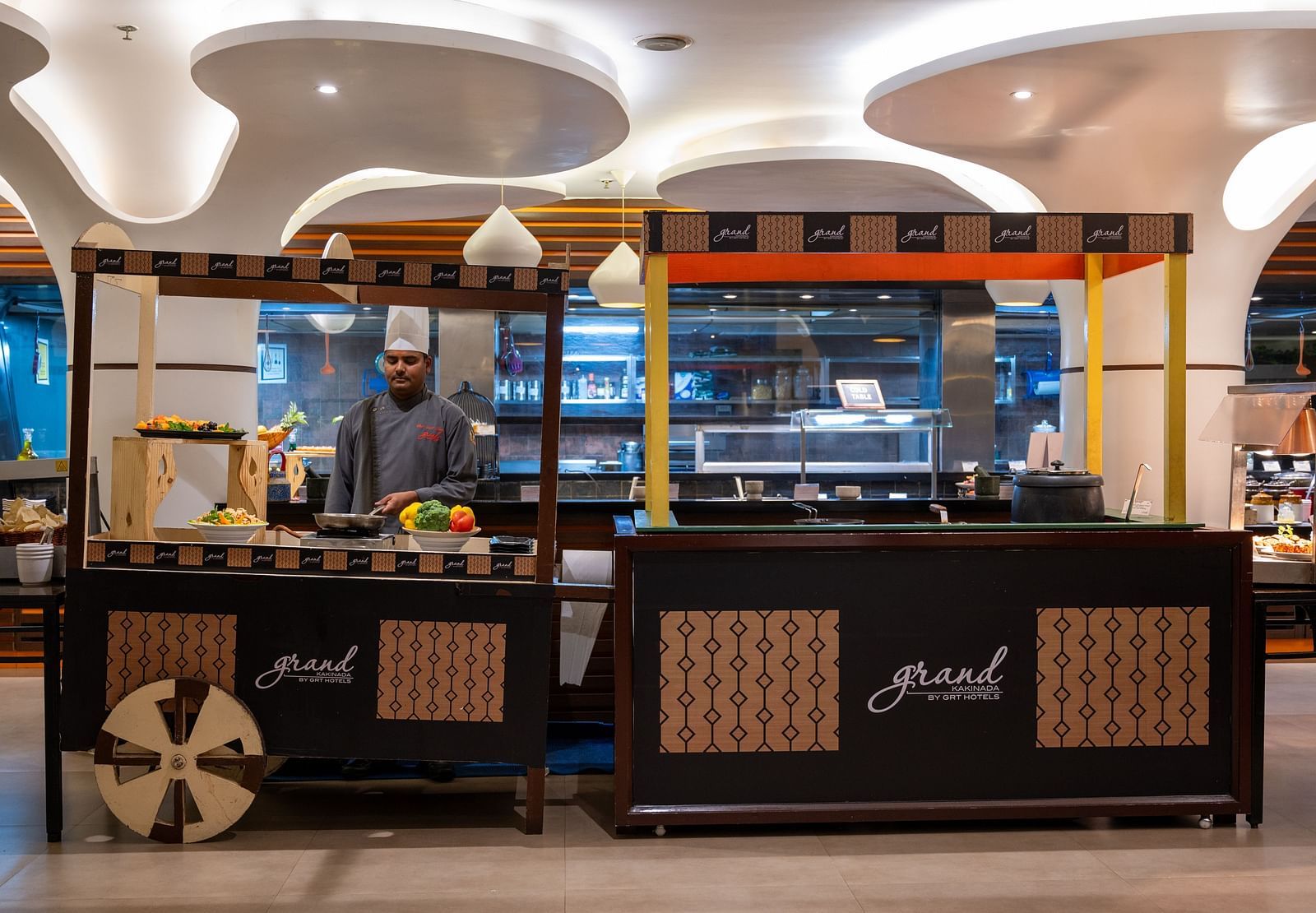 An image of a live kitchen with a chef at Grand Kakinada by GRT Hotels