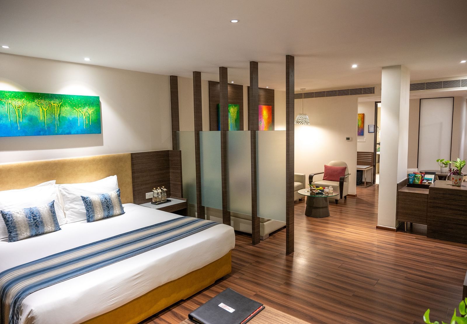An image of a bedroom with a living space at  Grand Kakinada by GRT Hotels