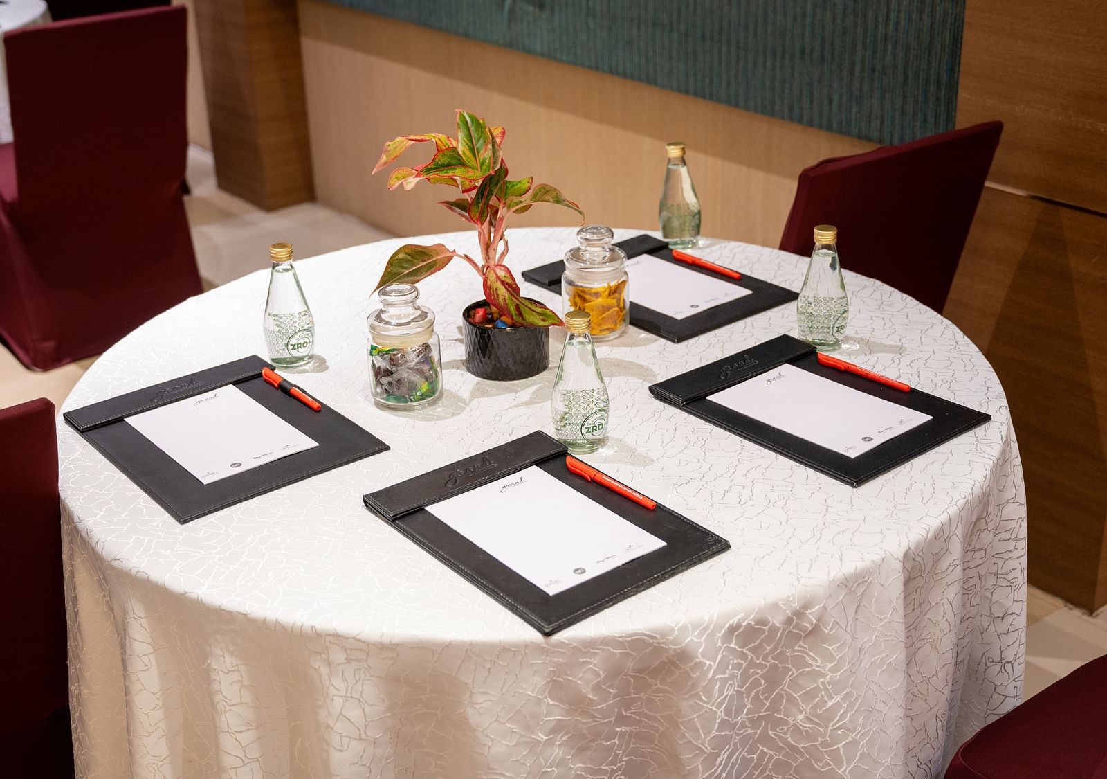 An image of note pads and glass bottles arranged on the table at Grand Kakinada by GRT Hotels