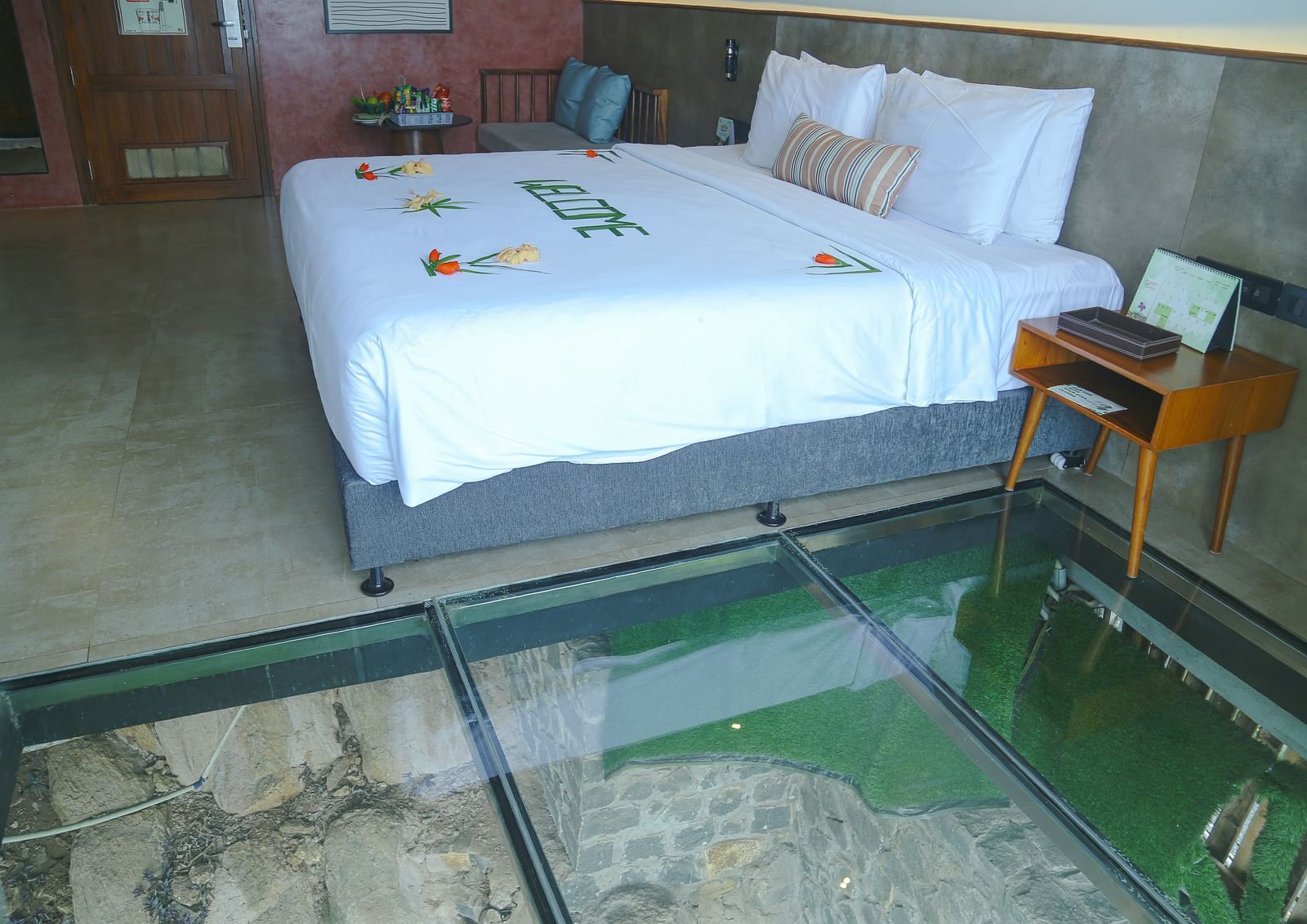 An image of a room with a panoramic view featuring king size bed, bed side table, and other modern amenities - Great Trails Yercaud by GRT Hotels