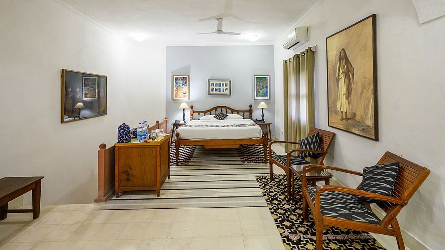 Hill Fort Kesroli 14th Century Alwar - interior view of the Sugni Mahal - Countryside View with a queen size bed, white walls and chairs