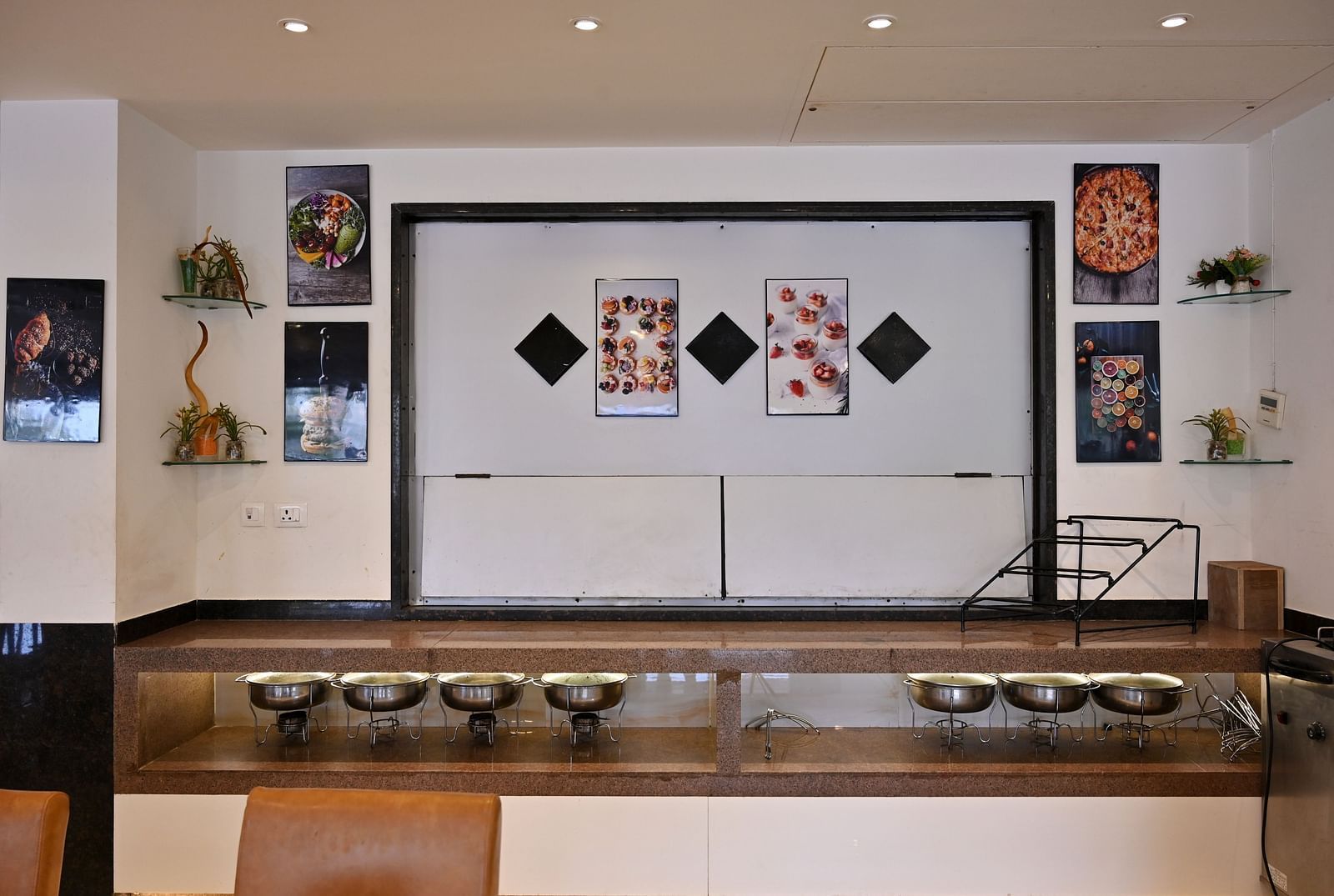 Buffet serving area with warming trays in a hotel restaurant - TGI Insignia, Bhopal