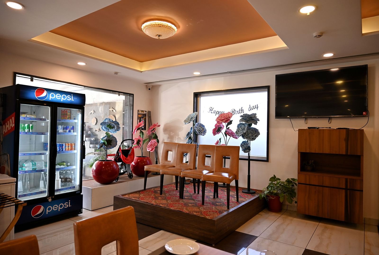 Cosy dining corner with a brown leather booth and wooden tables in a restaurant - TGI Insignia, Bhopal