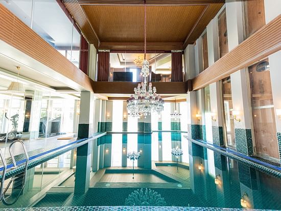 A swimming pool with a chandelier hanging above it - The Manor Luxury Hotel, Shimla