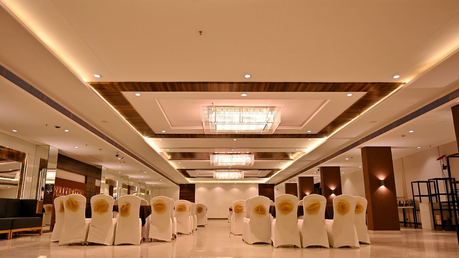 Well-arranged banquet hall at TGI Insignia with tables set for an event - TGI Insignia, Bhopal