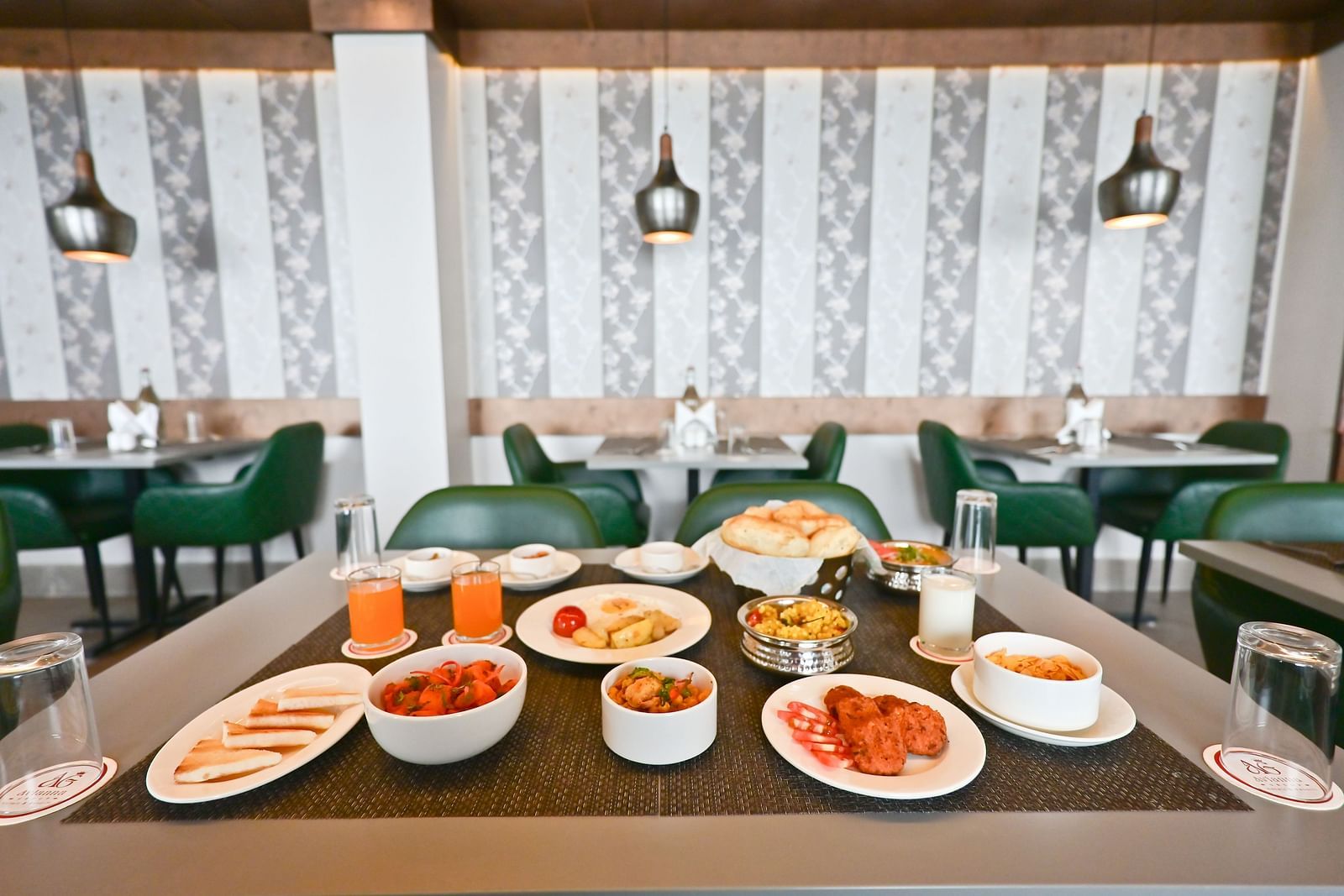 Image of a restuarant and a table filled with food  at The Soma Hotel by Avianna Group, Darjeeling