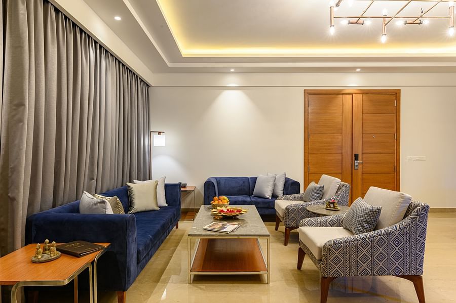 The living room of our Presidential Suites in Pushkar with  a sofa set, a television and a large window PS-4243