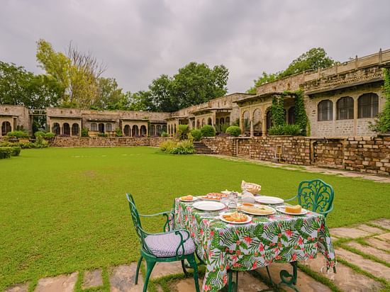 Lawn with table and chairs in front of a resort property