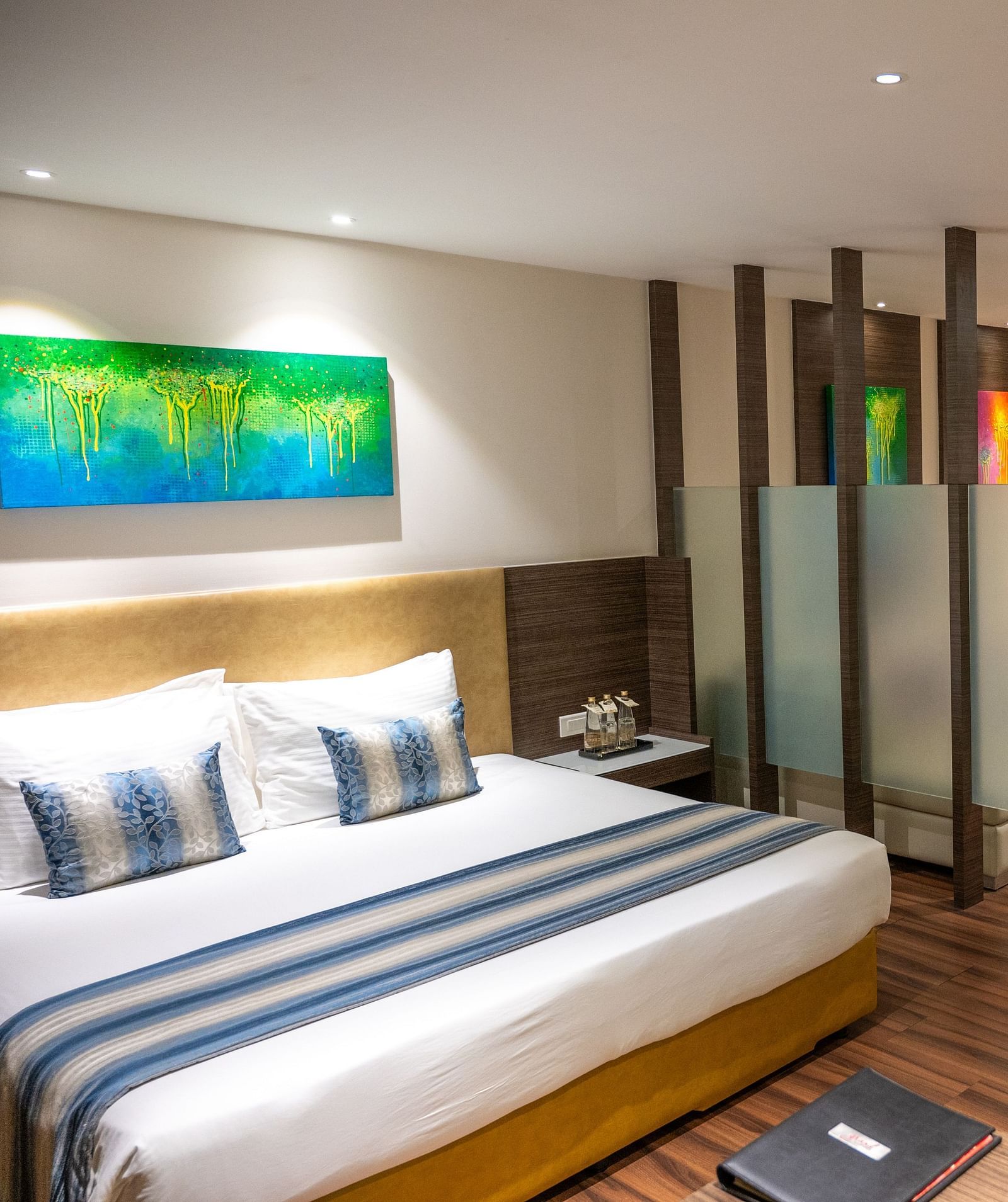 An image of a bedroom with a living space at  Grand Kakinada by GRT Hotels