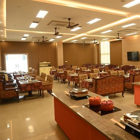A buffet counter along with variety of seating at Scoop Restaurant at Mayfair World Cup Village, Rourkela 3