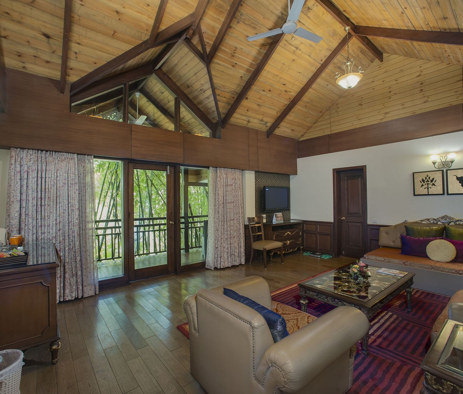 the living room decked with a sofa set and a TV kept above a cabinet - Mayfair Spa Resort & Casino Gangtok 1