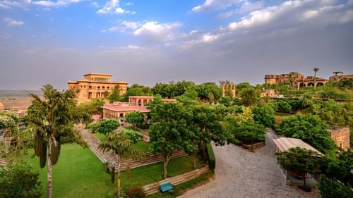 Facade view of Tijara Fort-Palace - 19th Century, Alwar with cloudy blue sky in the background.