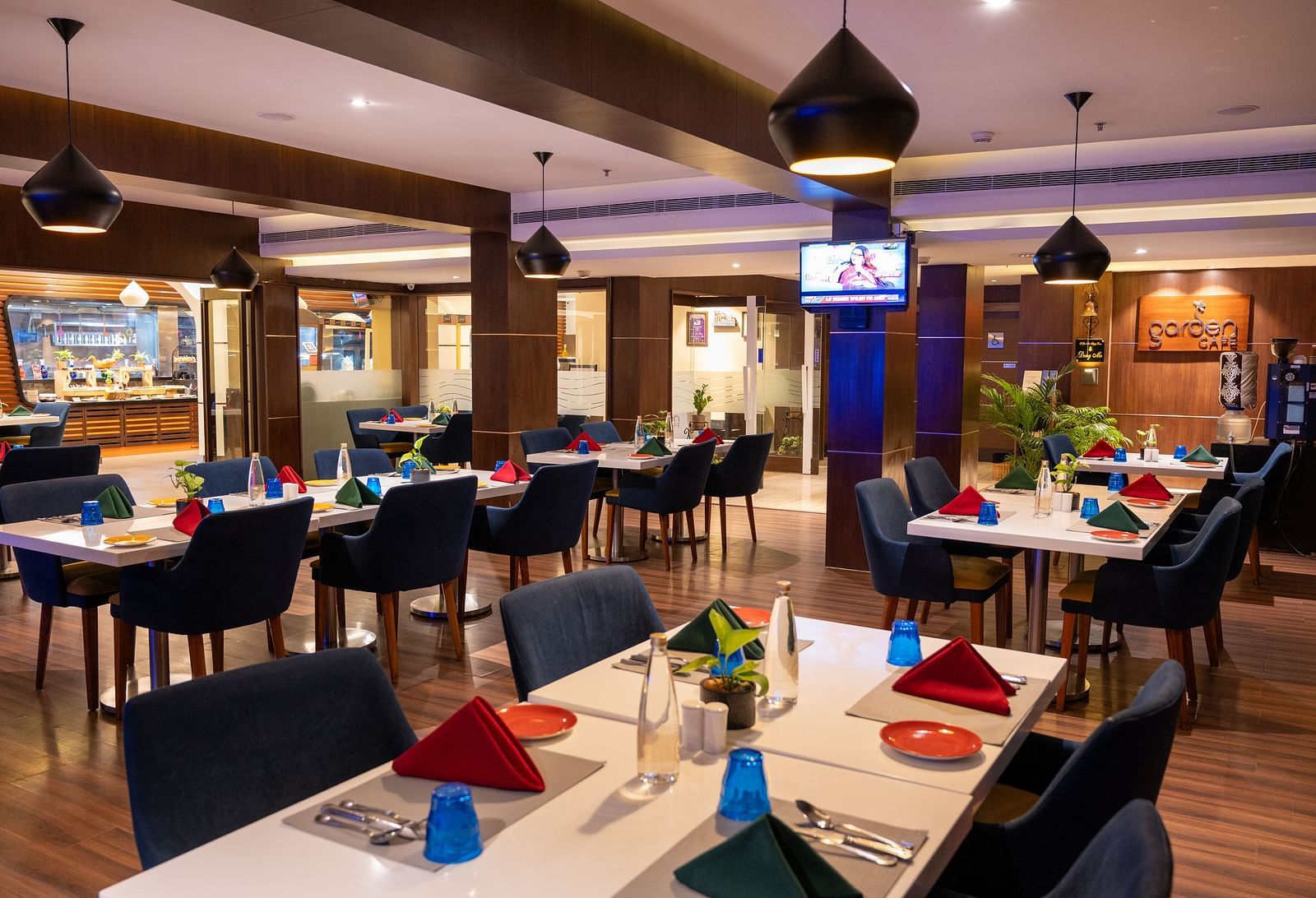 An image of  a dining space with a television  at Grand Kakinada by GRT Hotels