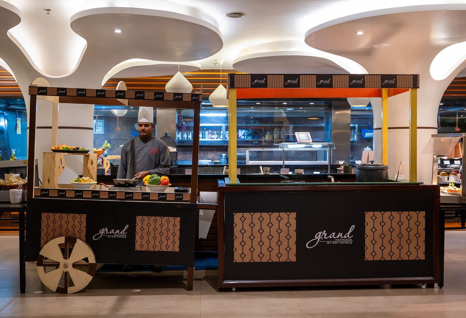 An image of a live kitchen with a chef at Grand Kakinada by GRT Hotels