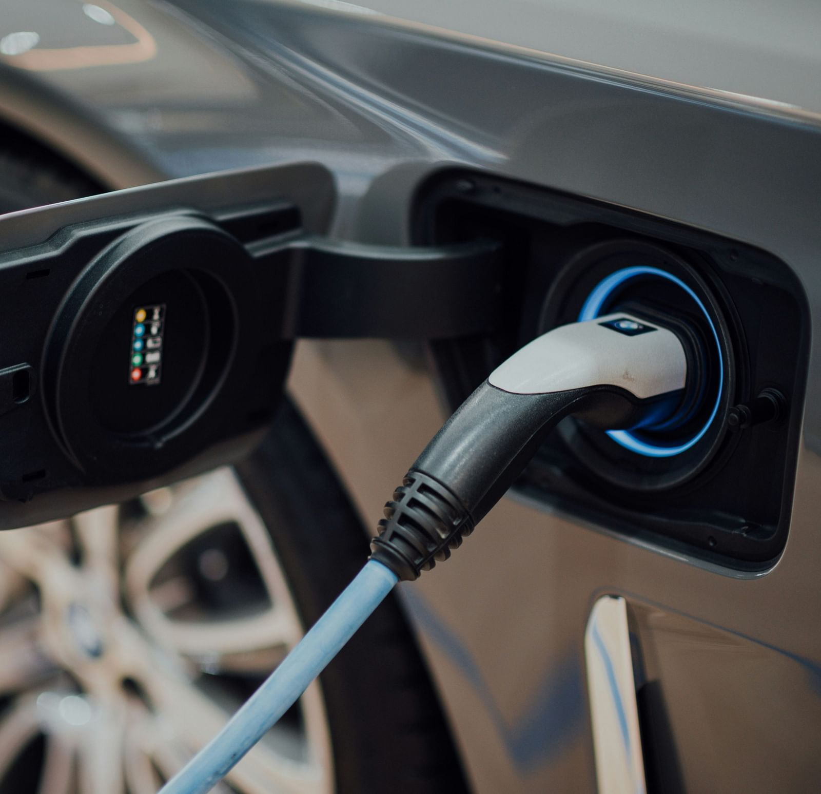 a car being charged from a wire that is plugged into the car