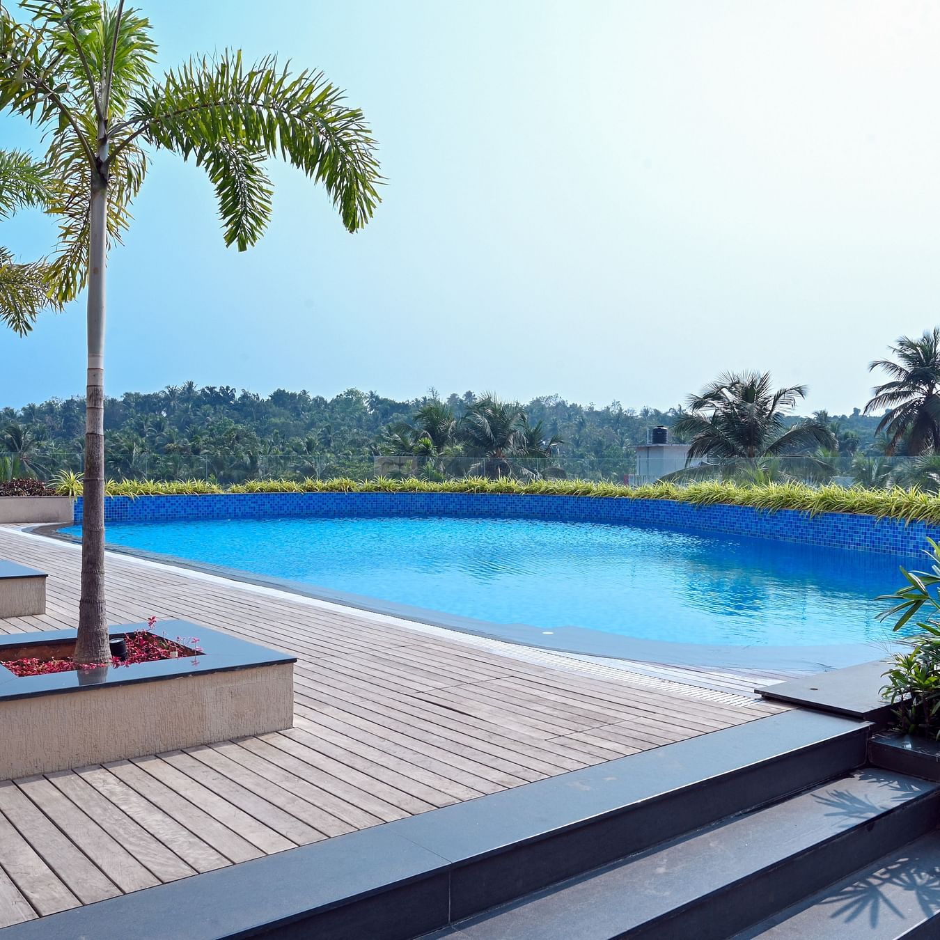 view of the swimming pool of Apollo Dimora hotel in Calicut